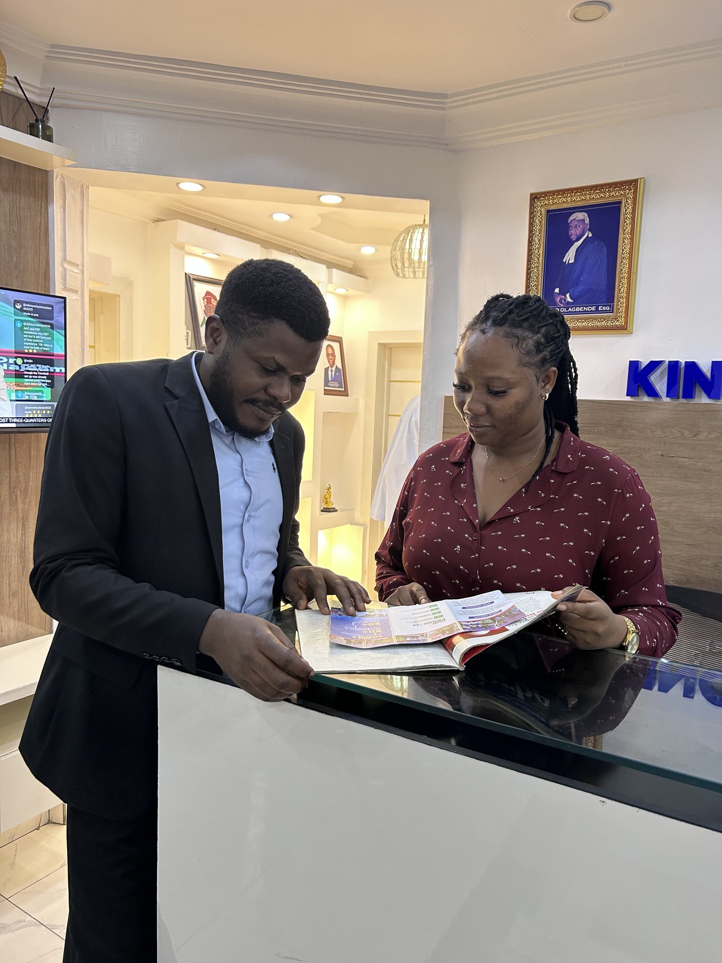 Two colleagues reviewing firm literature together at the front desk