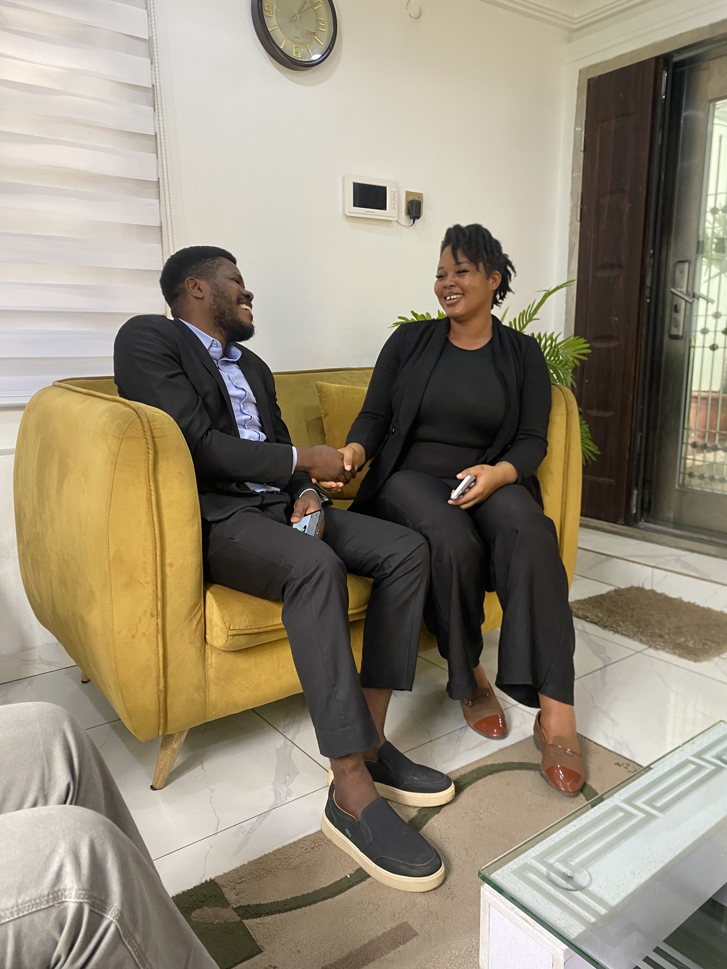 Counsel and a client shaking hands after a consultation at the office