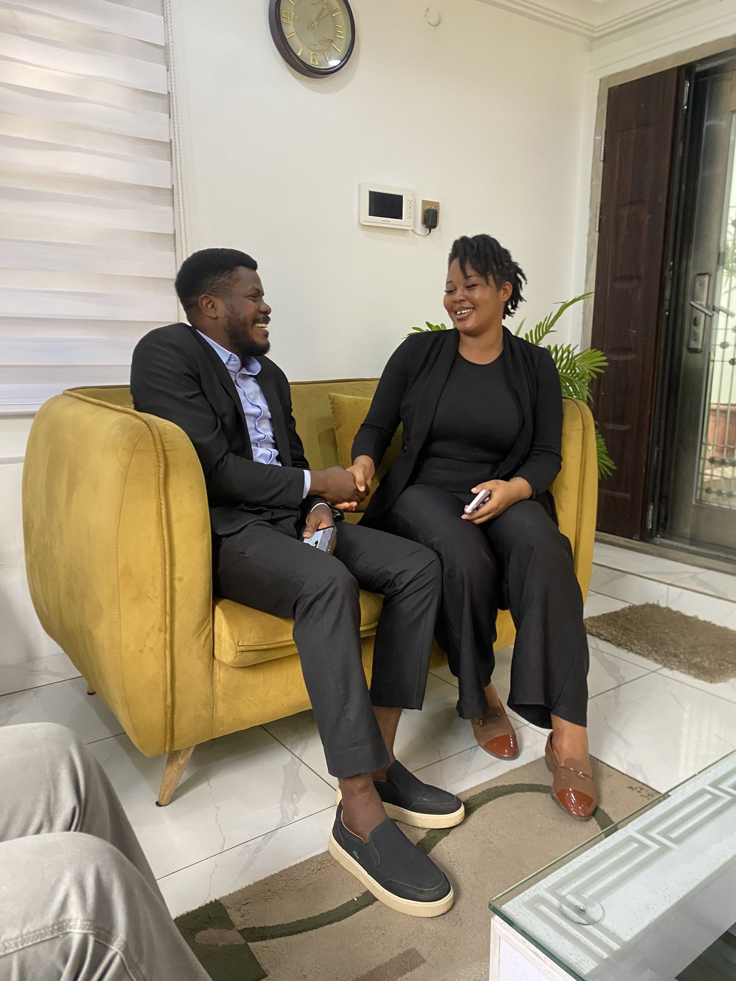A client meeting closing with a handshake in the Legal Climate lounge