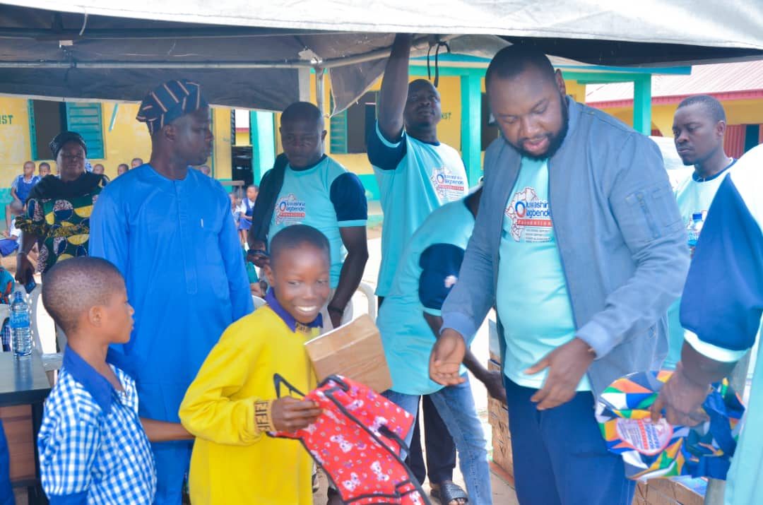 Pupils receiving school bags and materials from Foundation volunteers