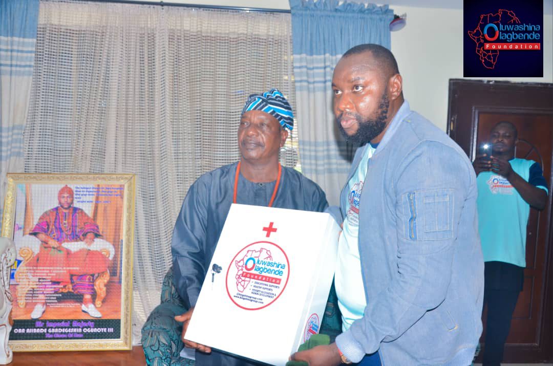 Foundation representatives presenting a medical kit to a community leader